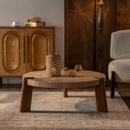 Wooden coffee table with a candle and glass in a room with wooden furniture and a rug.