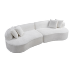 A modern curved modular sofa upholstered in a soft off-white fabric, featuring several matching throw pillows, shown against a plain white background.