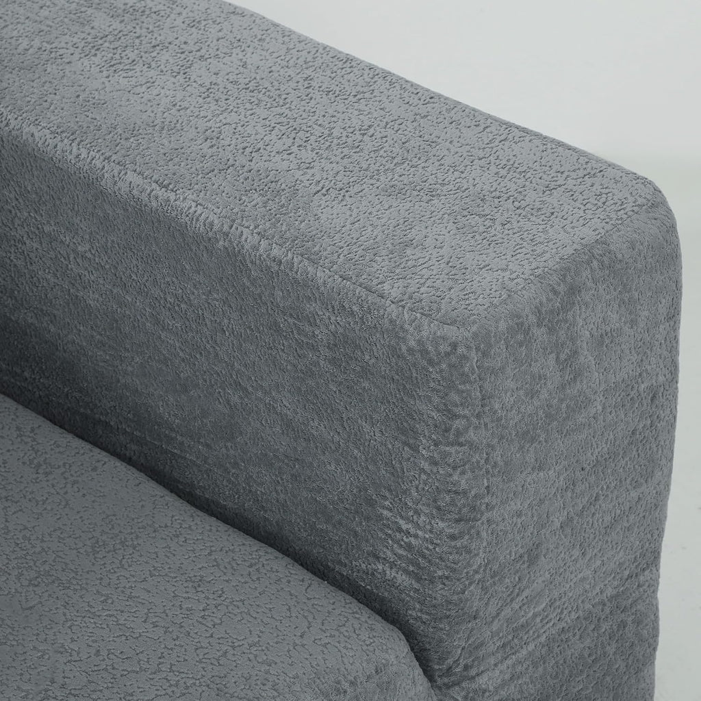 Gray textured armrest of a sofa on a light gray background
