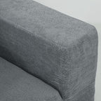 Gray textured armrest of a sofa on a light gray background